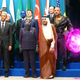 Obama poses for a photo with visiting alternate world leaders, including Master Command Droid Barack O-3, Supreme Leader Dukakis, and some 1,500 single-celled dignitaries.